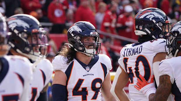 Jan 1, 2023; Kansas City, Missouri, USA; Denver Broncos linebacker Alex Singleton (49) celebrates with team mates after a fumble recovery against the Kansas City Chiefs during the first half at GEHA Field at Arrowhead Stadium.
